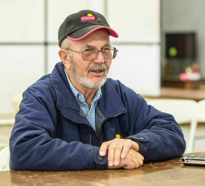 While many farmers are pleased that the new bill will maintain a strong crop insurance program, James Hughes of Philo Township, Ill., said he was indifferent because he never used crop insurance. Here, Hughes is shown sitting down at the Midwest Ag Expo at Gordyville’s lunch area on Jan. 30, 2014.