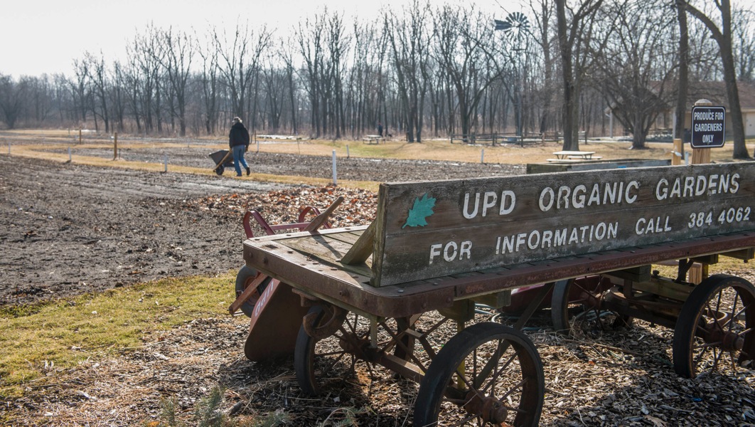  A park district worker prepares the organic gardens for use by residents in Meadowbrook Park in Urbana, March 14, 2014. 